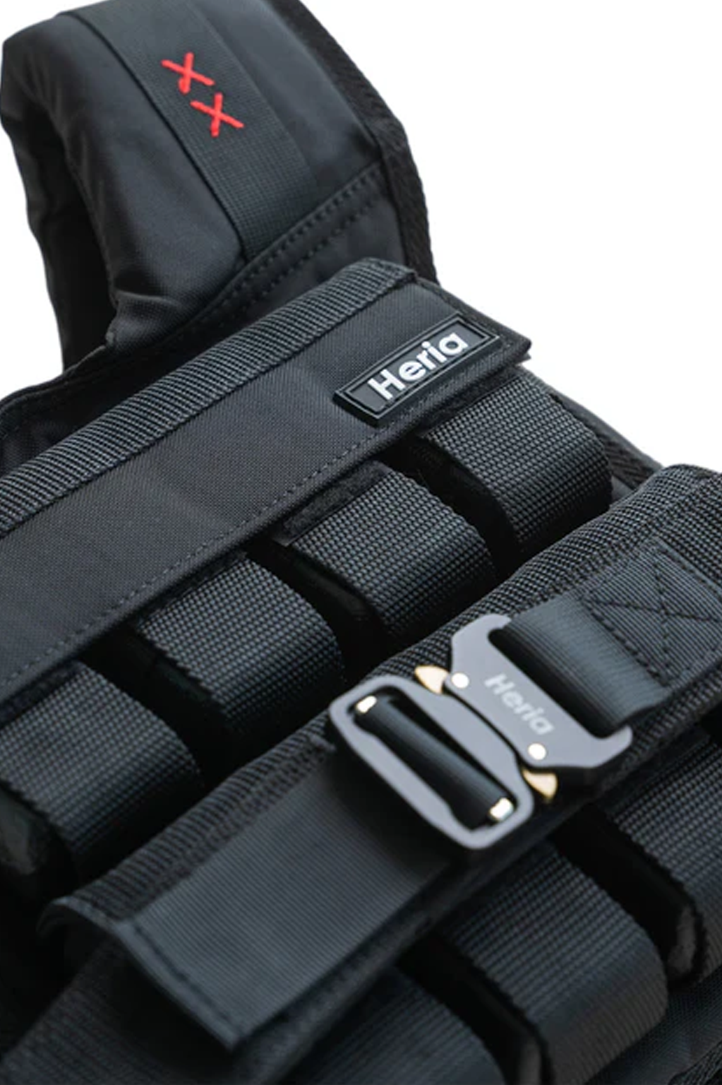 Close-up of Heria 35lb black weight vest showing the buckle and rubber logo details.